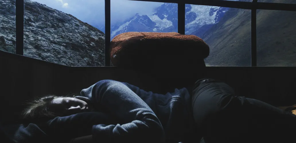 a sad person lying on a couch